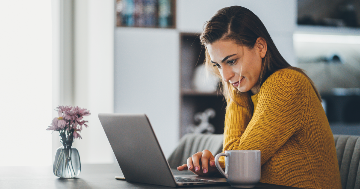 A woman is working on her laptop.