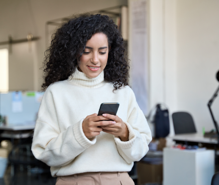 A woman is typing on her phone.